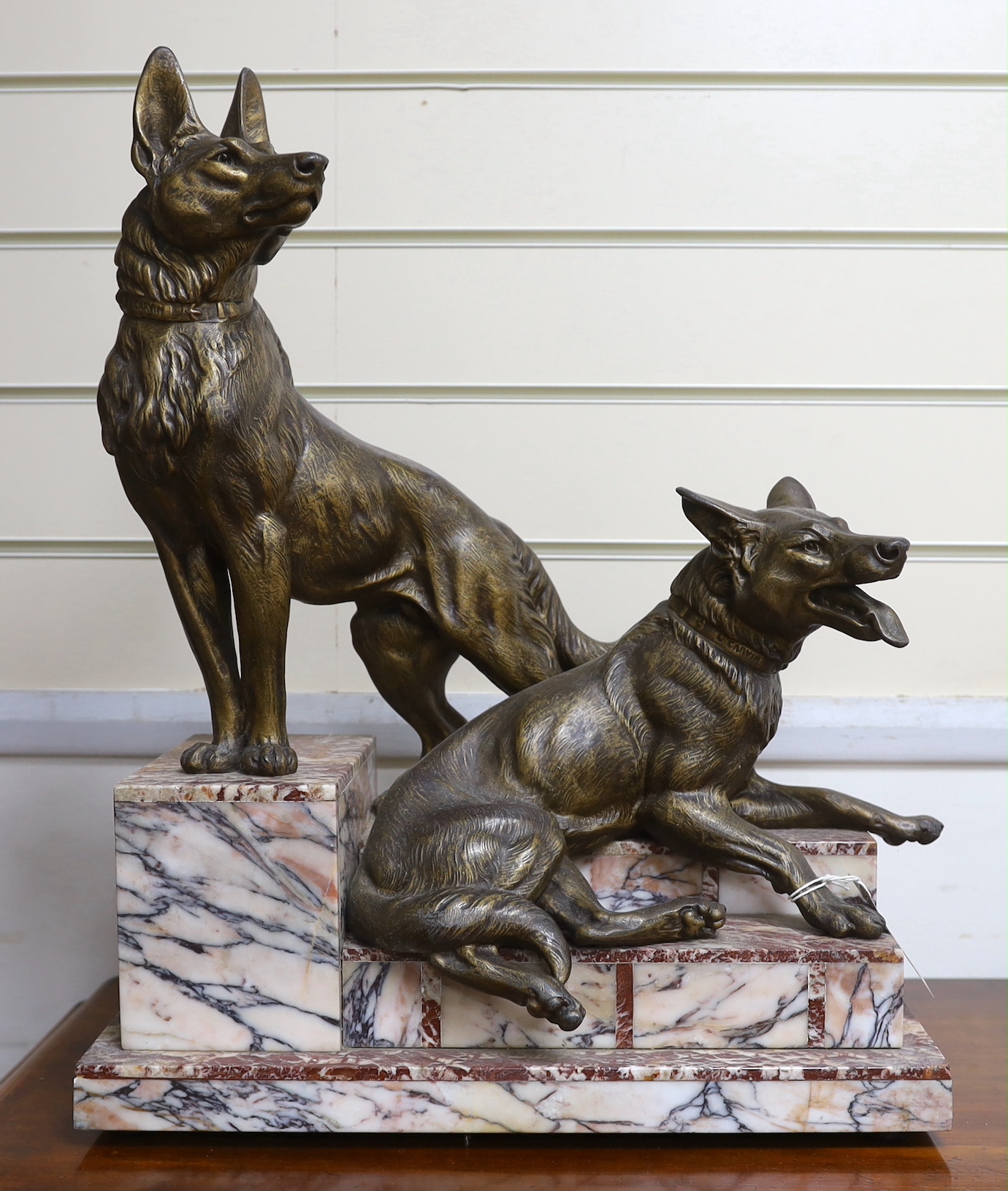 After Louis-Albert Carvin (1875–1951). A spelter Alsatian group on stepped marble base, 53cm tall